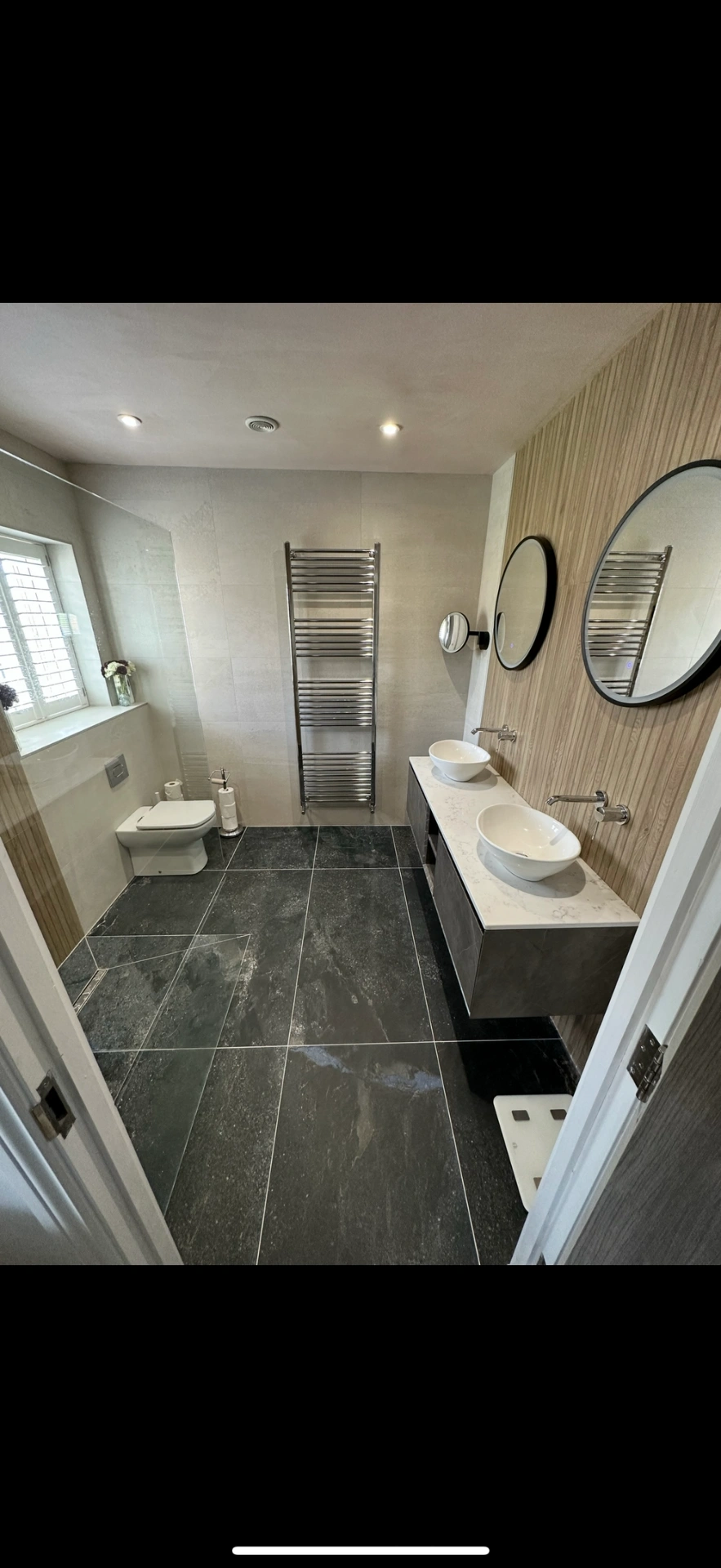 Spacious ensuite with slate floor, oak feature wall and twin vessel basins — Godalming