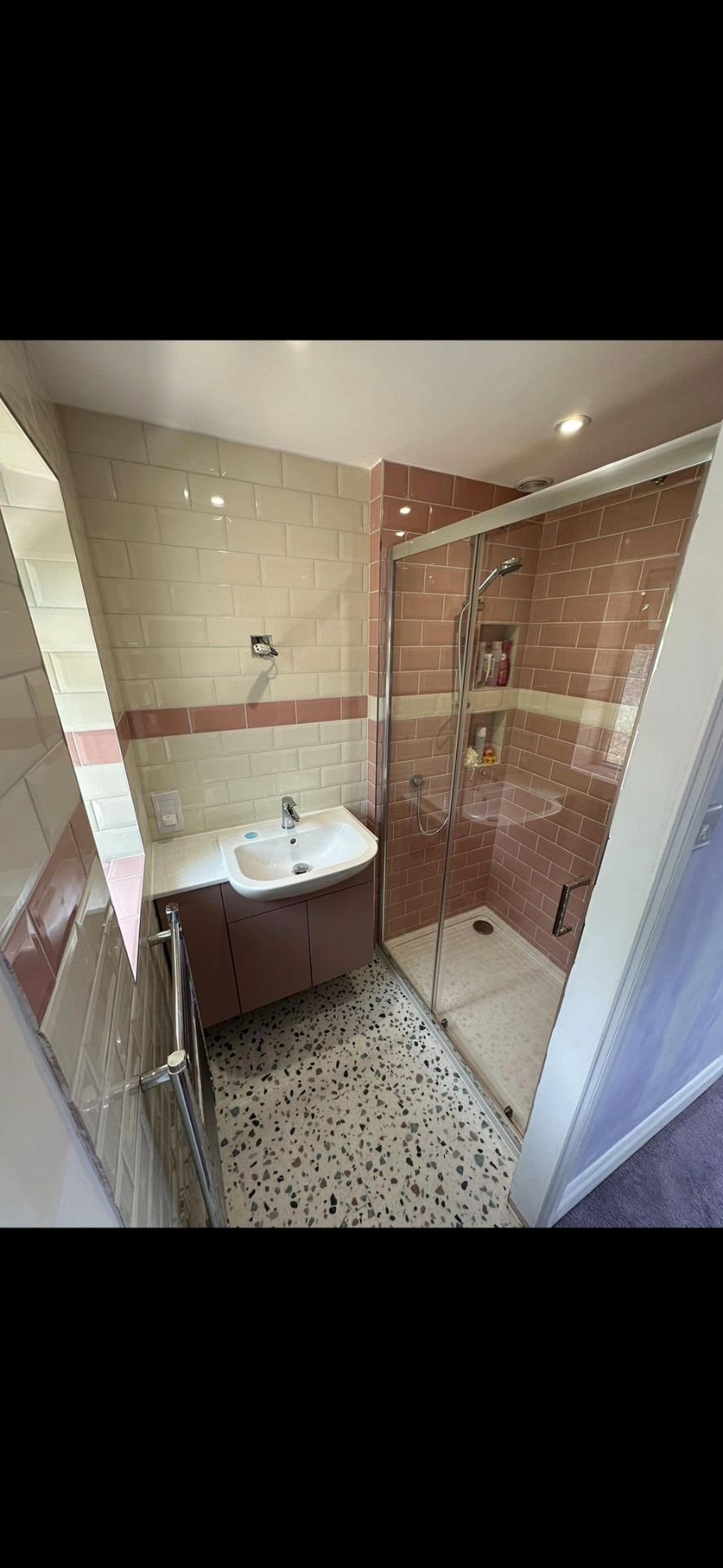 Pink and cream metro-tiled shower room with terrazzo floor — bathroom renovation Godalming