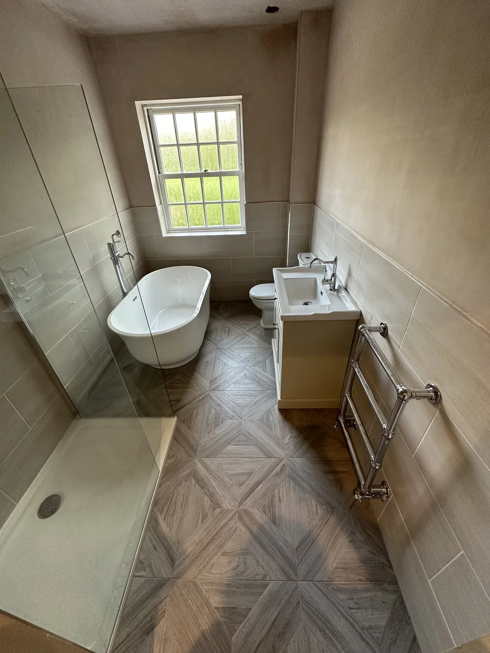 Traditional bathroom with freestanding slipper bath, cream shaker vanity and parquet floor — bathroom renovation Godalming